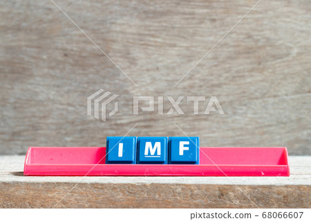 Tile letter on red rack in word IMF (abbreviation of International Monetary Fund) on wood background 68066607