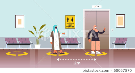 arab businesspeople in protective masks keeping distance to prevent coronavirus pandemic social distancing arab businesspeople in protective masks keeping distance to prevent coronavirus pandemic social distancing 68067870