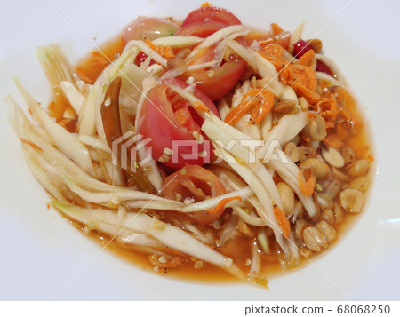 Close-up spicy Papaya salad dressing with carrots peanut dried shrimp and tomato, famous secret recipe of freshness thai eastern street food restaurant, food stylist backgrounds menu Close-up spicy Papaya salad dressing with carrots peanut dried shrimp and tomato, famous secret recipe of freshness thai eastern street food restaurant, food stylist backgrounds menu 68068250