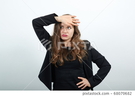 Tired Woman After Work Holds Hand On Her Forehead. Physical And Mental Fatigue 68070682