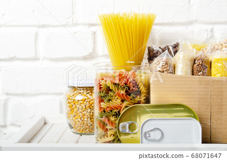 Set of uncooked foods on pantry shelf prepared for 68071647