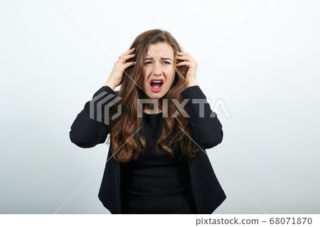 Angry, Irritated Female Holds Hands To Her Head And Screams. People's Hysteria 68071870