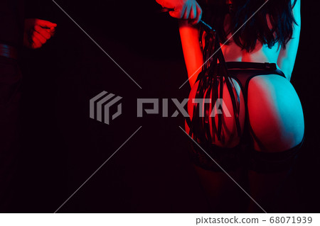 bdsm sex with domination and submission. A man touches a woman's sexy ass with a whip bdsm sex with domination and submission. A man touches a woman's sexy ass with a whip 68071939