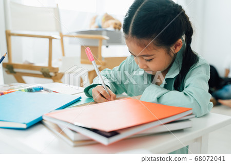 Asian girl doing homework 68072041