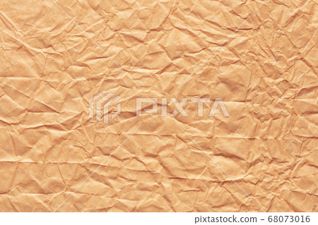 Crumpled paper background in peach color for your new stylish greeting card. 68073016