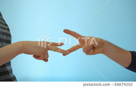 Hands of couple playing rock paper scissors 68074202