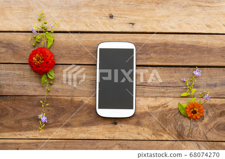 mobilie phone with colorful flower zinnia of lifestyle arrangment flat lay syle mobilie phone with colorful flower zinnia of lifestyle arrangment flat lay syle 68074270