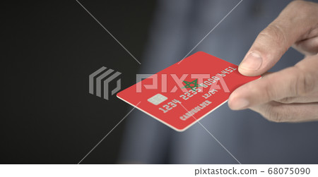 Man offers plastic bank card with printed flag of Morocco. Fictional numbers 68075090