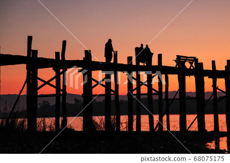 Silhouette of U Bein Bridge at sunrise near Silhouette of U Bein Bridge at sunrise near 68075175