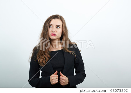 focused female holds clothes with hands, thinks. Smart people, intellectuals 68075292