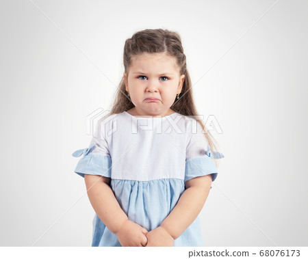Portrait of crying little girl on grey background 68076173
