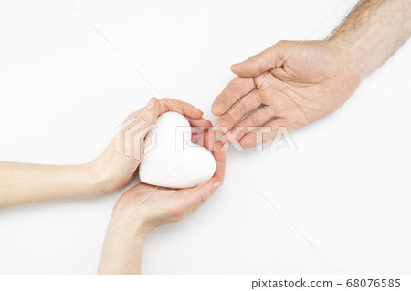 Woman gives heart to man isolated on white 68076585