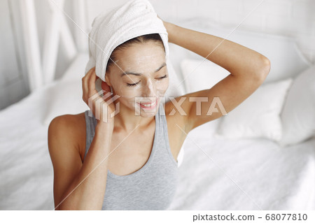 Beautiful girl sitting in a studio with cream Beautiful girl sitting in a studio with cream 68077810