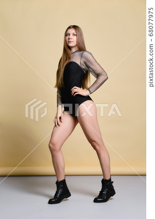 young woman in thight body suit and rough boots 68077975