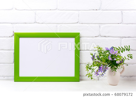 Green landscape frame mockup with purple bird 68079172