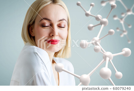 Beautiful adult woman near big white molecule chain. 68079240
