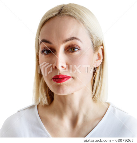 Portrait of beautiful serious adult woman in white blouse. Portrait of beautiful serious adult woman in white blouse. 68079265