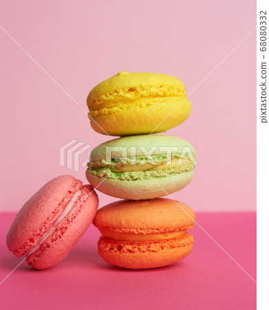 stack of baked macarons on pink background, 68080332