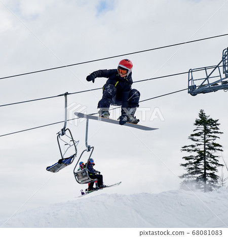 Winter kinds of sport. Skier doing tricks in the mountains in winter season Winter kinds of sport. Skier doing tricks in the mountains in winter season 68081083