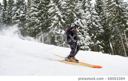 Winter kinds of sport. Skier doing tricks in the mountains in winter season Winter kinds of sport. Skier doing tricks in the mountains in winter season 68081084