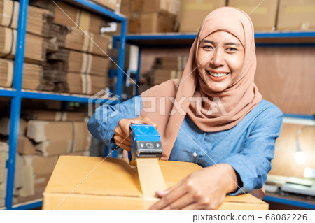 Islam Muslim warehouse worker packing goods Islam Muslim warehouse worker packing goods 68082226