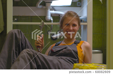 Happy woman with the wrench in her hands 68082609