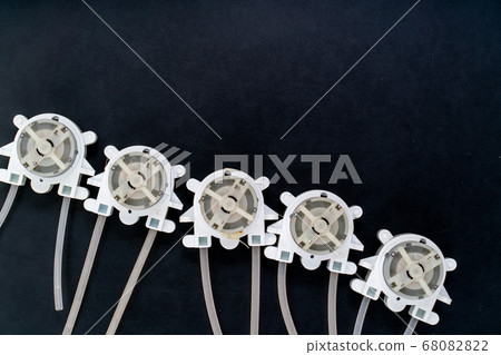 Peristaltic pump on a black background. 68082822