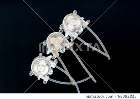 Peristaltic pump on a black background. 68082823