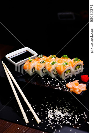 Sushi with salmon. Soy sauce, ginger, red caviar. Roles with red fish. Sushi with salmon. Soy sauce, ginger, red caviar. Roles with red fish. 68083371