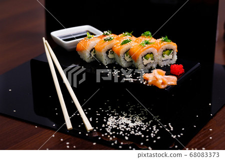 Sushi with salmon. Soy sauce, ginger, red caviar. Roles with red fish. Sushi with salmon. Soy sauce, ginger, red caviar. Roles with red fish. 68083373