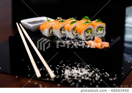 Sushi with salmon. Soy sauce, ginger, red caviar. Roles with red fish. Sushi with salmon. Soy sauce, ginger, red caviar. Roles with red fish. 68083408
