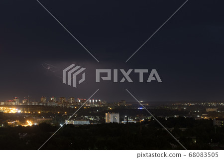 Lightning flashes in the night sky above the city Lightning flashes in the night sky above the city 68083505
