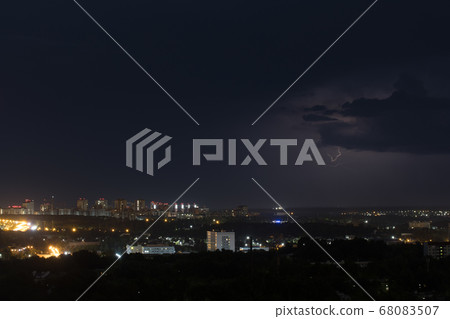 Lightning flashes in the sky above the city Lightning flashes in the sky above the city 68083507