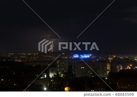 Thick lightning bolt strike the ground in the city Thick lightning bolt strike the ground in the city 68083509