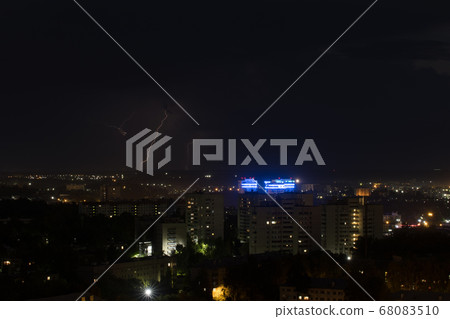 Several lightning bolts strike the ground in the city Several lightning bolts strike the ground in the city 68083510