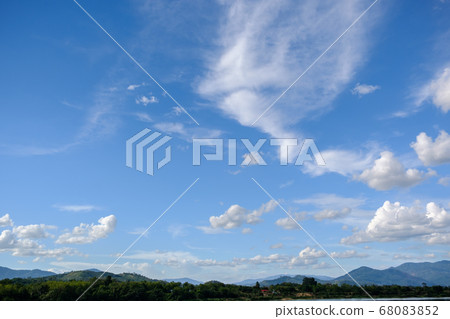The white clouds have a strange shape and moutain.The sky and the open space have mountains below.Clouds floating above the mountains. The white clouds have a strange shape and moutain.The sky and the open space have mountains below.Clouds floating above the mountains. 68083852