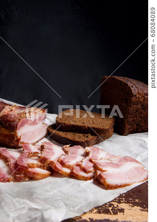 Puff smoked bacon with rye black bread on the Puff smoked bacon with rye black bread on the 68084089