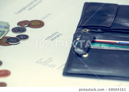 Man signs a utilities invoice with a ballpoint pen Man signs a utilities invoice with a ballpoint pen 68084161