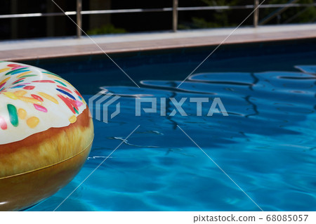 Inflatable donut ring in blue swimming pool 68085057