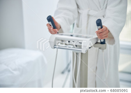 Woman holding hands on the dashboard modern technology device in beauty clinic 68085091
