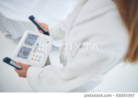 Woman is checking health indicators with body composition analyzed machine 68085097