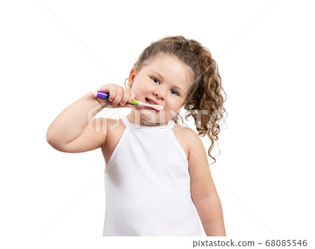 Cute blond girl brushing her teeth on isolated white background. Cute blond girl brushing her teeth on isolated white background. 68085546
