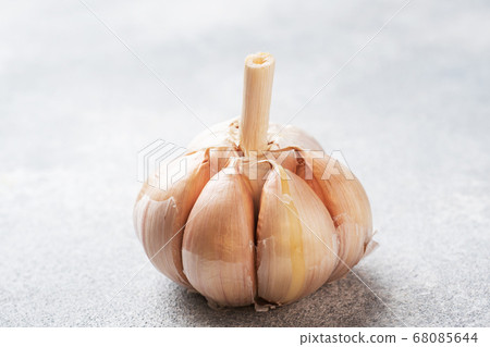 Whole garlic heads on a concrete grey background. Whole garlic heads on a concrete grey background. 68085644