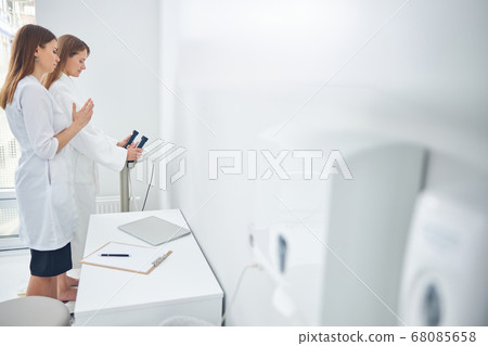 Two beautiful women measuring indicators of the health Two beautiful women measuring indicators of the health 68085658
