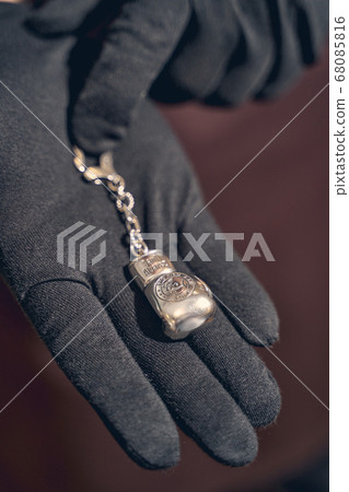 Silver charm lying on a jeweler palm Silver charm lying on a jeweler palm 68085816