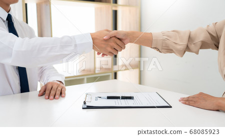 Two confident business man shaking hands during a Two confident business man shaking hands during a 68085923