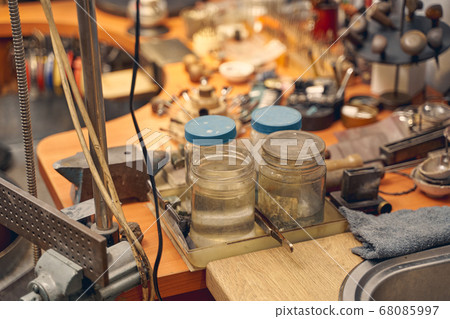 Containers with etching solution on the jeweler desk Containers with etching solution on the jeweler desk 68085997
