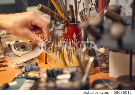 Male hand choosing a bur among the toolkit Male hand choosing a bur among the toolkit 68086012