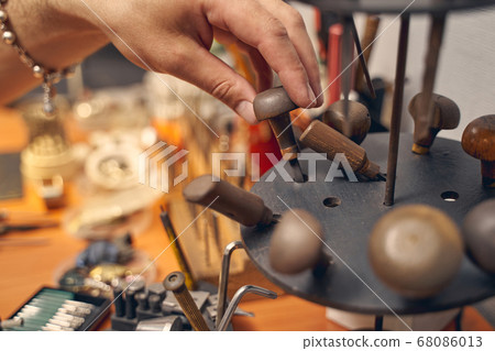 Caucasian male hand touching a jewelry instrument Caucasian male hand touching a jewelry instrument 68086013