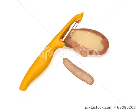 Yellow peeler, used to peel potatoes on white background. Knife, peeler for vegetables and fruits 68086208